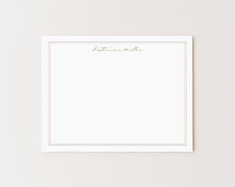 May include: A white stationery card with a double border and the name "Katherine Miller" in a delicate script. The card is rectangular and has a clean, minimalist design, perfect for personalized notes or invitations.