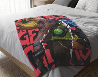 May include: A red, white, and black throw blanket with a graphic of a video game character. The character is wearing a green jacket and has a green and yellow weapon. The text "GET GOOD" is printed on the blanket.