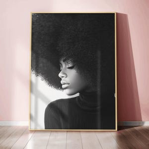 May include: Black and white portrait of a person with an afro hairstyle wearing a black turtleneck sweater.
