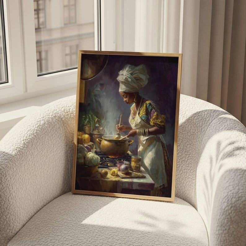 May include: A framed print of a woman cooking in a kitchen. The woman wears a white head wrap, apron, and colorful patterned top. A pot simmers on the stove, surrounded by vegetables and jars. The artwork has a warm, inviting color palette.
