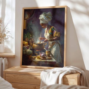 May include: A framed art print depicts a woman in a kitchen, stirring a pot on a stove. She wears a white head wrap, apron, and a colorful patterned top. The kitchen scene includes vegetables, fruit, and a pot emitting steam. The artwork is in a wooden frame.