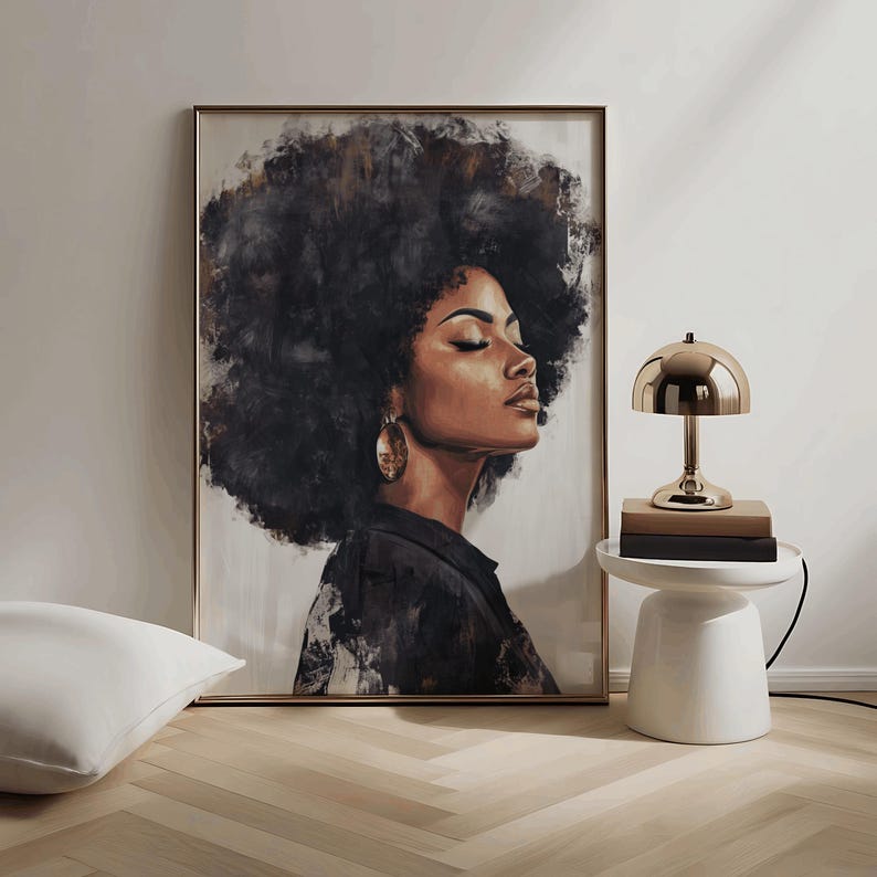 May include: A painting of a woman with a large afro hairstyle, wearing a black shirt and gold earrings. The painting is in a gold frame and is hanging on a white wall.