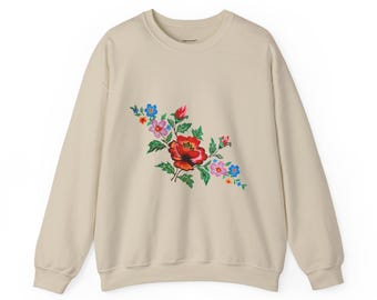 El vibrante diseño floral añade elegancia a un clásico atemporal: la sudadera de cuello redondo Heavy Blend™.