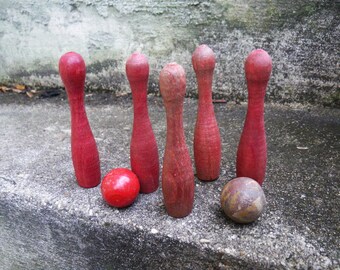 Vintage child's bowling pin game - red wooden pins and ball