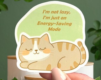 May include: A green and white sticker with a cartoon cat sleeping and the text "I'm not lazy, I'm just on Energy-Saving Mode".