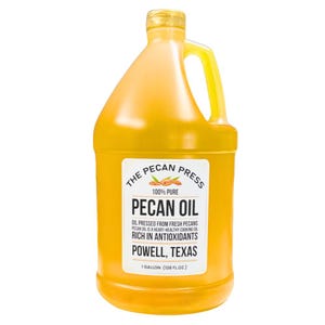May include: A gallon jug of 100% pure pecan oil from The Pecan Press. The label is yellow with black text and features a pecan nut graphic. The oil is pressed from fresh pecans and is rich in antioxidants. The label also states that the oil is a heart-healthy cooking oil. The jug is made of clear plastic and has a yellow cap.