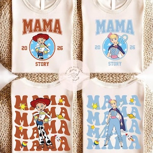 May include: Four off-white t-shirts with the word "MAMA" in different colors and fonts. Each shirt features a cartoon character from the movie "Toy Story" and the text "20 26 STORY". The shirts are on a woven background.