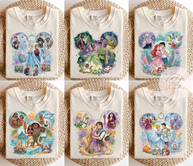 May include: A collection of six cream-colored t-shirts, each featuring a watercolor-style graphic of various animated characters arranged in a Mickey Mouse ear silhouette. The designs depict scenes from popular films including Frozen, The Princess and the Frog, The Little Mermaid, Moana, Tangled, and Cinderella.