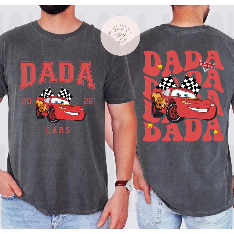 May include: Dark gray t-shirt with a red "DADA" graphic and a cartoon race car. The front design includes the text "20 26 CARS". The back of the shirt repeats "DADA" with a race car and stars.