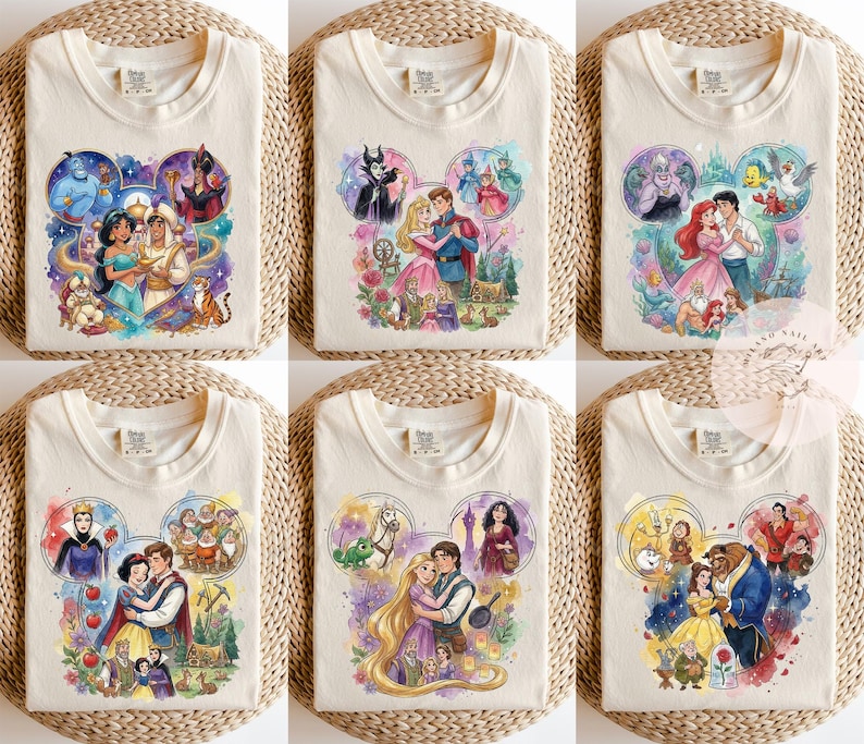 May include: A collection of six off-white t-shirts, each featuring a different watercolor-style graphic of Disney characters arranged in a Mickey Mouse ear silhouette. The designs include scenes from Aladdin, Sleeping Beauty, The Little Mermaid, Snow White, Tangled, and Beauty and the Beast.