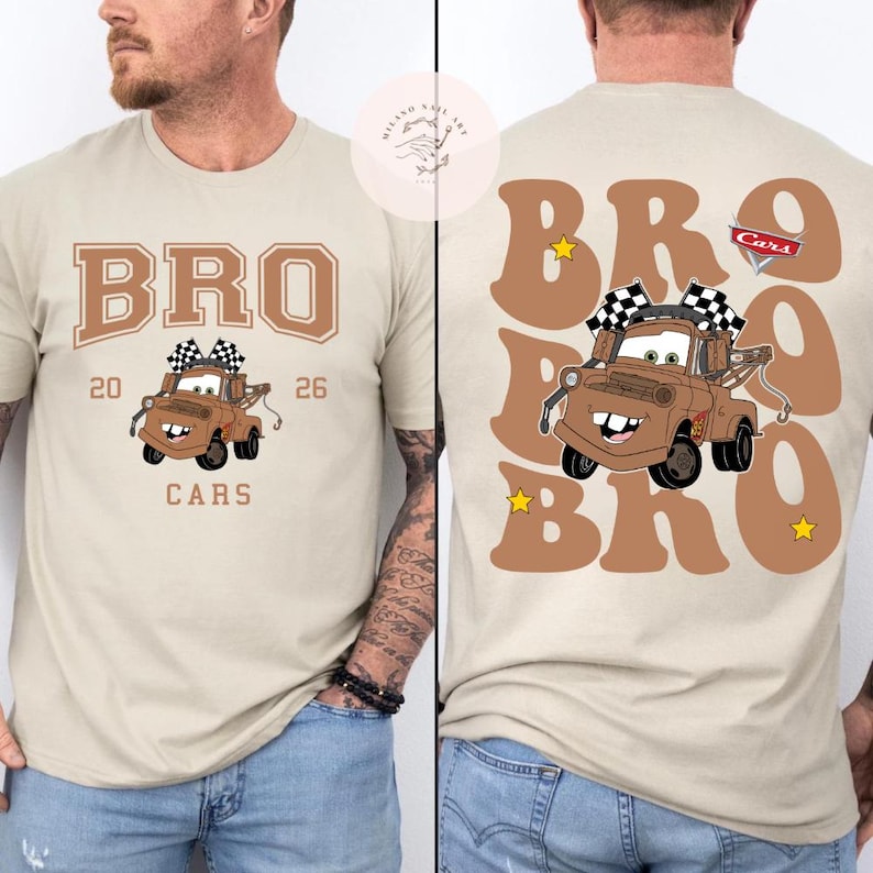 May include: Tan t-shirt featuring a cartoon tow truck with the word "BRO" above it. The front of the shirt has "BRO", the tow truck, "20", "26", and "CARS". The back of the shirt has "BRO" in large letters with the tow truck and "CARS" logo.
