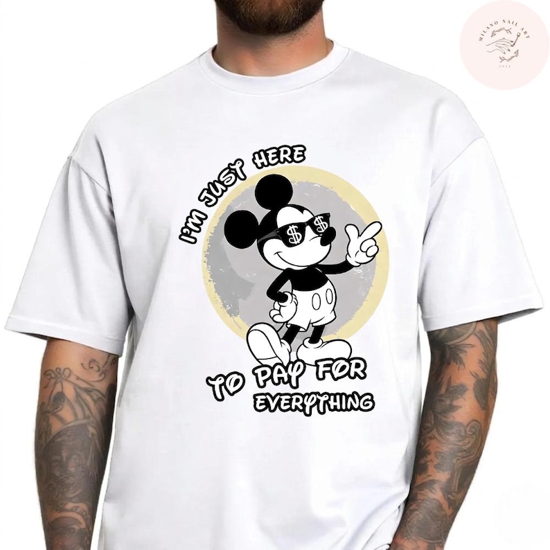 May include: White t-shirt featuring a cartoon Mickey Mouse character wearing sunglasses with dollar signs. The text on the shirt reads "I'M JUST HERE TO PAY FOR EVERYTHING". The design is in black and white.