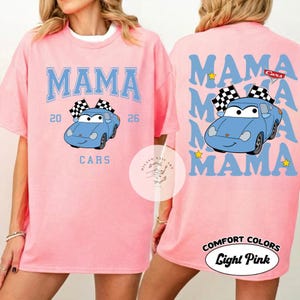 May include: Light pink t-shirt with a blue graphic design. The front features the word "MAMA" above a blue cartoon car with checkered flags, the numbers "20" and "26", and the word "CARS". The back repeats "MAMA" with the car.
