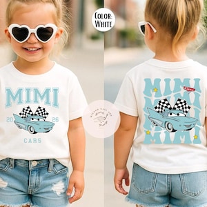 May include: White t-shirt with a light blue car graphic and the word "MIMI" in light blue. The shirt also features the text "CARS" and the numbers "20" and "26". The back of the shirt has a similar design.