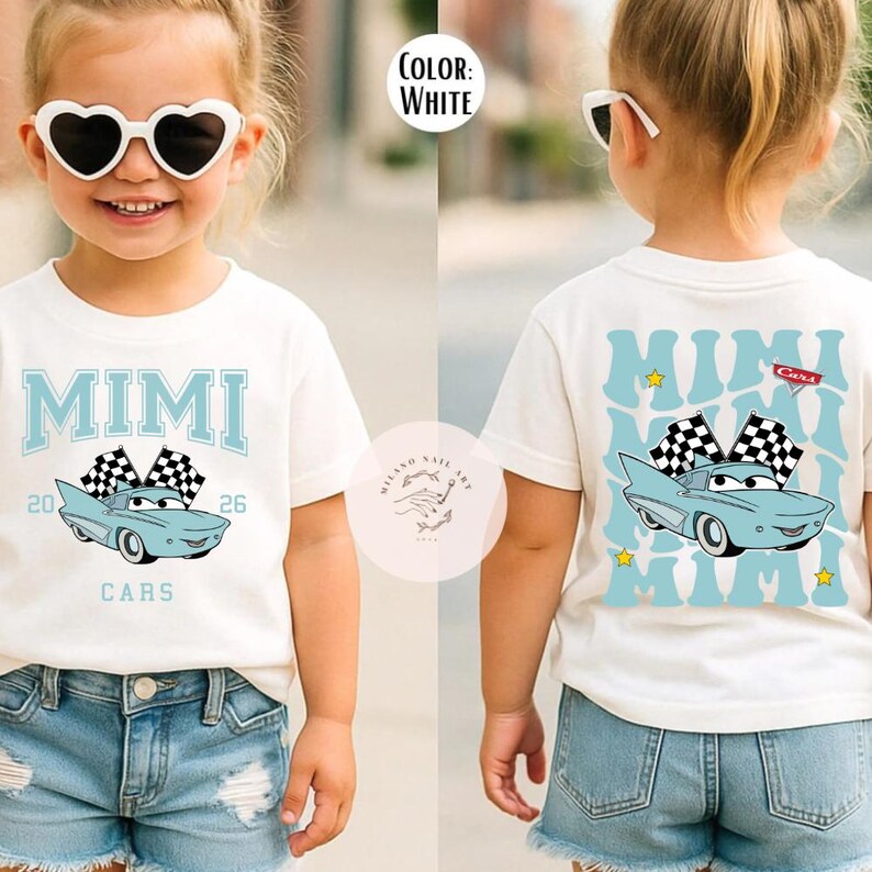 May include: White t-shirt with a light blue car graphic and the word "MIMI" in light blue. The shirt also features the text "CARS" and the numbers "20" and "26". The back of the shirt has a similar design.