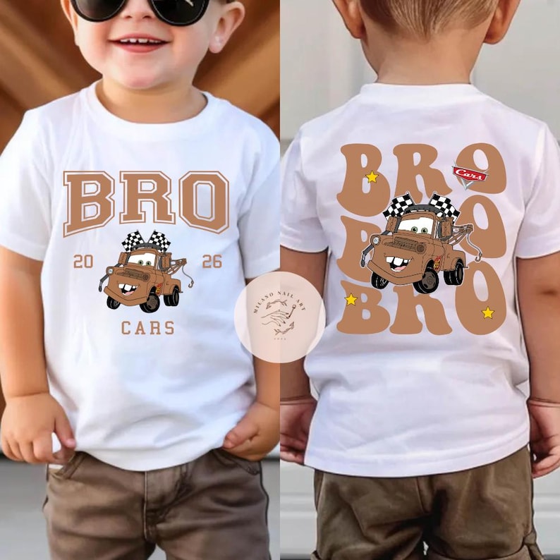 May include: White t-shirt featuring a cartoon image of Tow Mater from the Cars movie. The front of the shirt has the word "BRO" above the image, with "20 26" and "CARS" below. The back of the shirt has the word "BRO" in large letters.