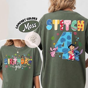 May include: Olive green t-shirt featuring colorful graphics of Stitch and Lilo. The front of the shirt says "Birthday Girl" in a playful font. The back displays "Stitch" and the number "4".