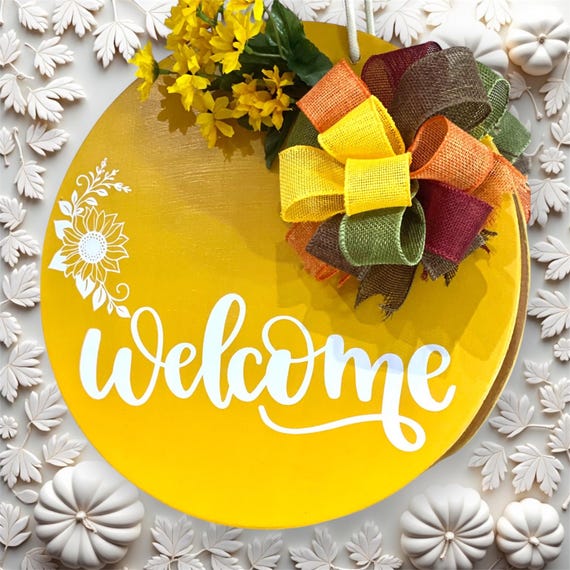 Say “hello” to autumn with this cheerful  round Welcome Door Hanger