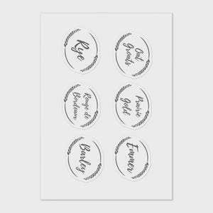 May include: Six circular stickers with handwritten text and wheat-like border designs. The stickers include the words "Rye", "Oat Groats", "Rouge de Bordeaux", "Prairie Gold", "Barley", and "Emmer". The stickers are arranged in two rows of three.