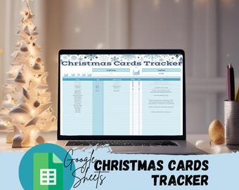 May include: A laptop displays a "Christmas Cards Tracker" spreadsheet. The screen shows a blue and white table with columns for tracking Christmas cards. A decorative white Christmas tree and pencils in a metal cup are on the desk.