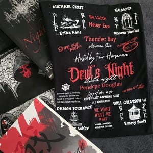 May include: A black t-shirt with white text that reads "Devil's Night, devil's right" and "Penelope Douglas". The shirt also features other text in red and white, including "Be Lilith, Never Eve", "Thunder Bay, Adventure Cave", "Hosted by Four Horsemen", "Lappel que vide, Never Let Anyone See", "Damon Torrance", "Will Grayson III", "We Want What We Want", "Chaos, Anarchy, Violence, Secret", and "Emory Scott".