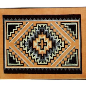 May include: A framed cross-stitch design with a geometric pattern in shades of orange, black, white, and gray. The design is centered on a light orange background.