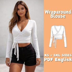 May include: A white wraparound blouse with long sleeves and a V-neck, tied at the waist. The image also includes a line drawing of the blouse and text that reads "Wraparound Blouse" and "XS - 5XL SIZES PDF English".