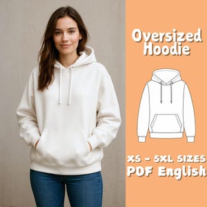 May include: A cream-coloured oversized hoodie with a front pocket and drawstring hood. The image also features a line drawing of the hoodie and text that reads "Oversized Hoodie", "XS - 5XL SIZES", and "PDF English". The person is wearing blue jeans.