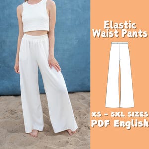 May include: A white pair of wide-leg pants with an elastic waistband. The pants are shown on a model wearing a white crop top. The text "Elastic Waist Pants" and "XS - 5XL SIZES PDF English" is shown in the image.
