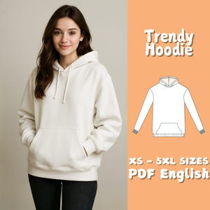 May include: A cream-coloured hoodie with a drawstring hood and a front kangaroo pocket. The image includes the text "Trendy Hoodie" and "XS - 5XL SIZES PDF English". The hoodie is shown on a person wearing black jeans.