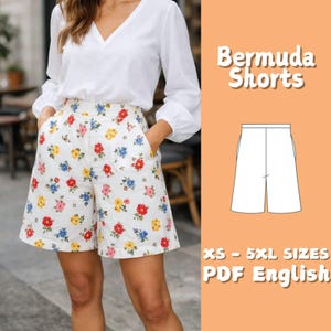 May include: Bermuda shorts featuring a white base with a repeating floral pattern in red, yellow, and blue. The shorts have a high waist and side pockets. The image includes the text Bermuda Shorts and XS - 5XL Sizes PDF English.