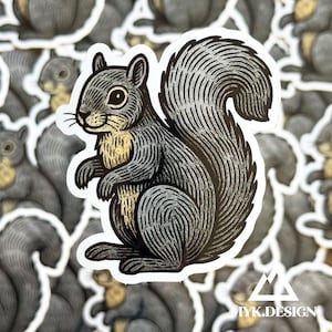 May include: A sticker featuring a detailed illustration of a squirrel in shades of gray and gold. The squirrel is depicted in a side profile, with a fluffy tail and a white border. The sticker has the text "MYK.DESIGN" at the bottom.