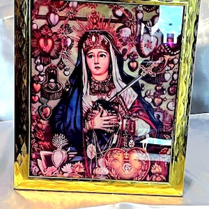 May include: A framed religious image of the Virgin Mary with a crown of thorns and a sword. The image is surrounded by hearts and flowers. The frame is gold and has a decorative design.