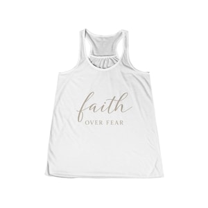 May include: White tank top with a racerback design. The shirt features the words "faith OVER FEAR" in a light brown script across the front. The tank top is made of a soft, lightweight material.