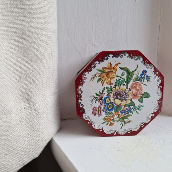 Vintage biscuit tin: vintage screen printed brightly coloured biscuit tin with bouquet motif, small octagonal vintage biscuit or cookie tin