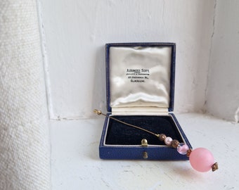 Glass stick pin: long gold tone pink glass bead plain Victoriana style gold tone hat, hair or stick pin; hat pin or hair pin with stopper