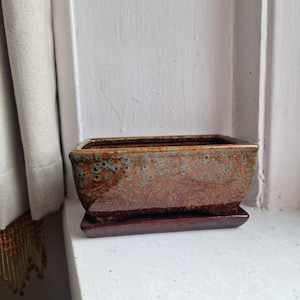 May include: A rustic wooden sign with the words "Welcome to our home" in white lettering. The sign has a distressed finish and a simple, inviting design, ideal for front door decor.