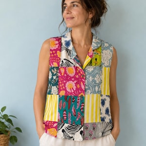 May include: A sleeveless button-down shirt featuring a vibrant patchwork design. The fabric displays a mix of patterns including zebra stripes, floral motifs, yellow and white vertical stripes, and colorful feathers in shades of pink, teal, and yellow.