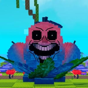 May include: A pixelated sculpture of a smiling face with a large grin, black eyes, and a pink and blue color scheme. The sculpture is surrounded by green foliage and red wheelbarrows on a grassy area, with a blue sky background.