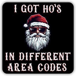May include: Black square sticker featuring a cartoon Santa Claus wearing sunglasses and a red hat. The text reads "I GOT HO'S IN DIFFERENT AREA CODES" in a white, stylized font with red accents. The Santa illustration has a white beard.