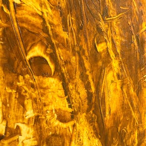 May include: Abstract artwork with a textured surface. The painting features a blend of golden yellow and brown hues, applied with visible brushstrokes. The artwork's composition is dominated by vertical and diagonal lines.