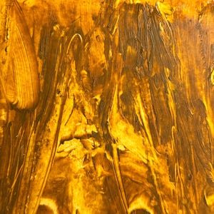May include: Abstract painting with a textured surface. The artwork features a blend of golden yellow and brown hues, applied with visible brushstrokes. The strokes create a dynamic, flowing pattern across the canvas, evoking a sense of movement and depth.