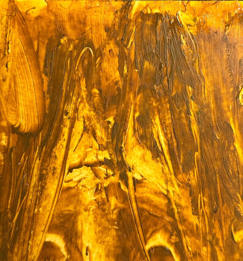 May include: Abstract painting with a textured surface. The artwork features a blend of golden yellow and brown hues, applied with visible brushstrokes. The strokes create a dynamic, flowing pattern across the canvas, evoking a sense of movement and depth.