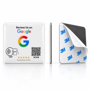 May include: A square white NFC review sign featuring the Google logo, text reading Review Us on Google, a QR code, five yellow stars, and a TAP icon. The reverse side shows a black adhesive backing with a partially peeled white 3M protective liner.