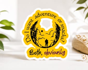 May include: A yellow sticker with black text and a silhouette of a hiker in a mountain scene. The text reads "Do I want adventure or snacks? Both, obviously."