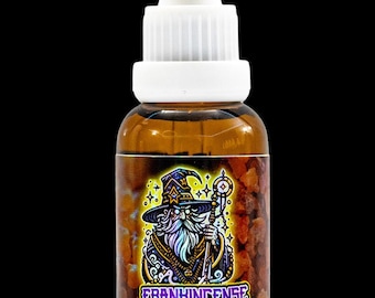 May include: A brown glass bottle with a white dropper top. The label features a cartoon illustration of a wizard with a beard and a hat. The text on the label reads "Frankincense & Myrrh 1 oz Beard Oil."