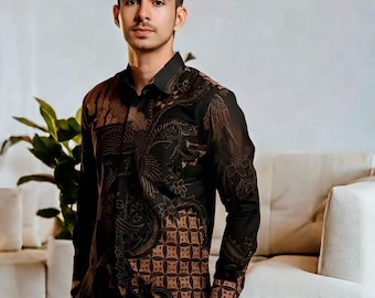 May include: Black long-sleeve button-down shirt with a brown floral and geometric pattern. The shirt features a collared neckline and buttoned cuffs. The shirt is made of a lightweight fabric and has a tailored fit. The shirt is from NindyaCrafts.
