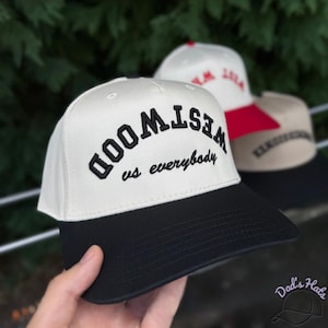 May include: A set of three ceramic mugs with a speckled, matte finish. The mugs are in shades of cream, light brown, and dark brown. Each mug has a simple, minimalist design, perfect for coffee or tea.