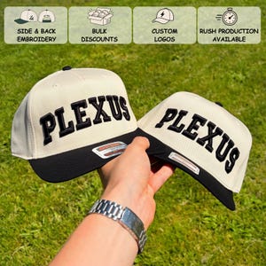 May include: Two baseball caps with cream-colored crowns and black brims. Each cap features the word PLEXUS embroidered in bold black letters across the front. The image includes text icons for side and back embroidery, bulk discounts, custom logos, and rush production.