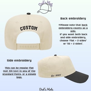 May include: Cream-colored baseball cap with a black brim and a black button on top. The back of the cap has the word "CUSTOM" embroidered in black. The side of the cap has the text "Est. 2025".
